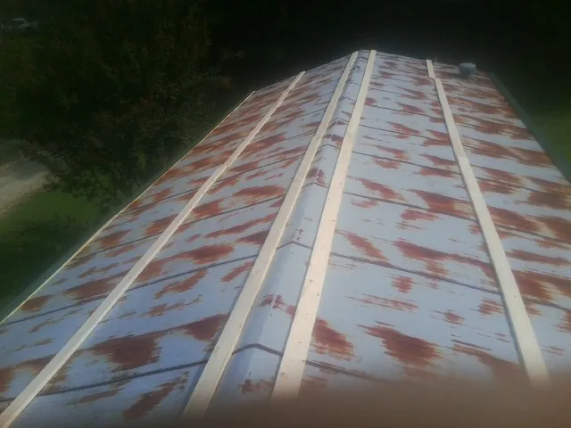 Rusted metal roof panels with new wood purlins before replacement — Storm Damage Roof Repair in Leslie by Roofing Brothers